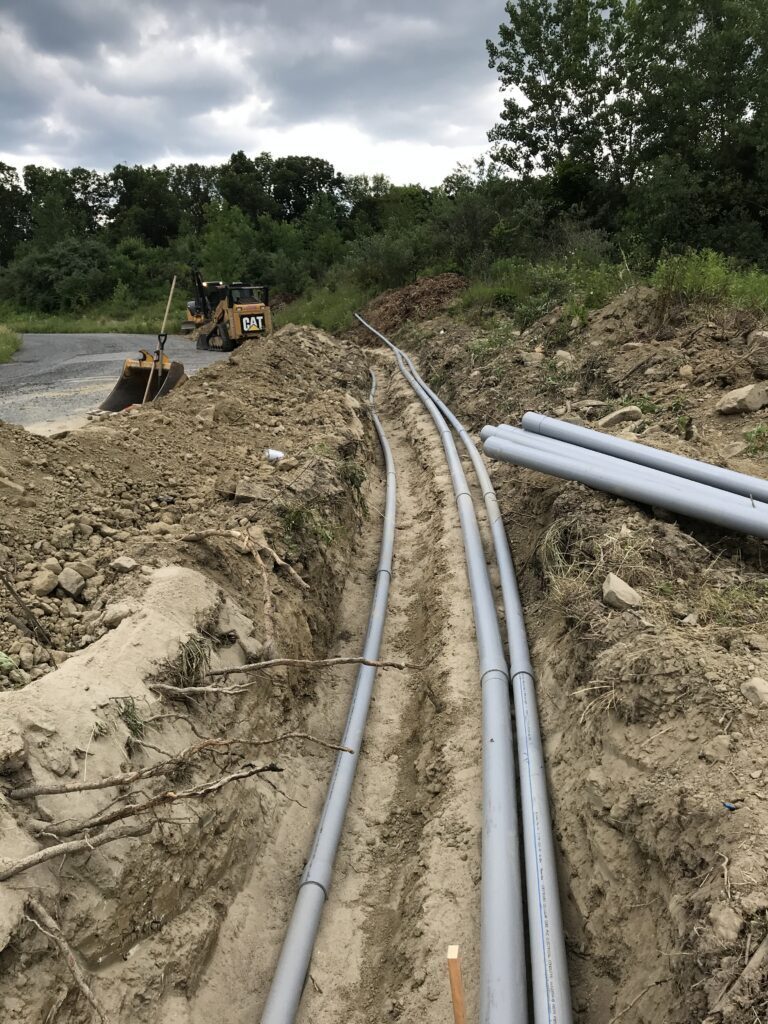 Conduits being installed in a trench