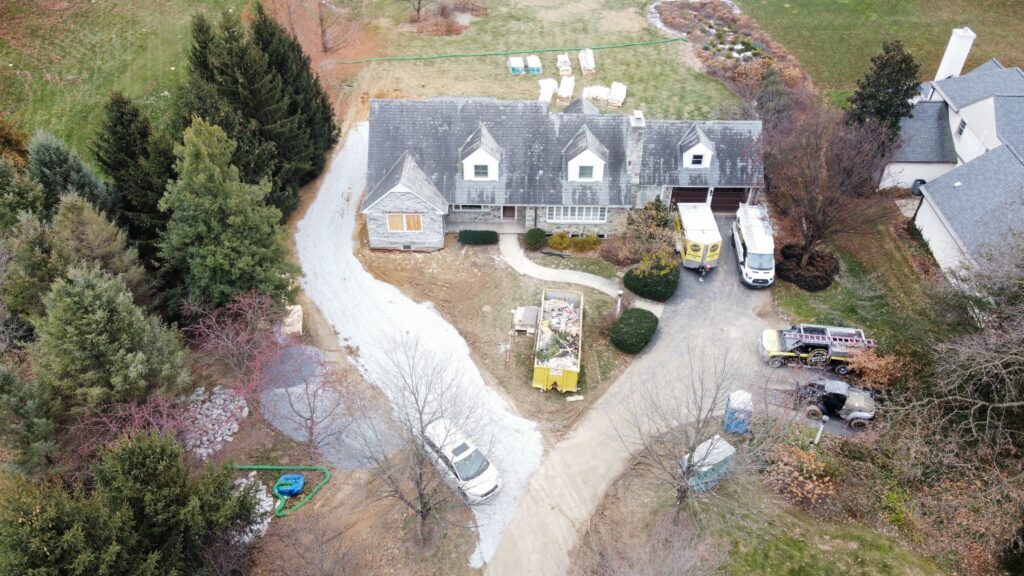 Aerial view of the house and addition under construction, from the opposite side