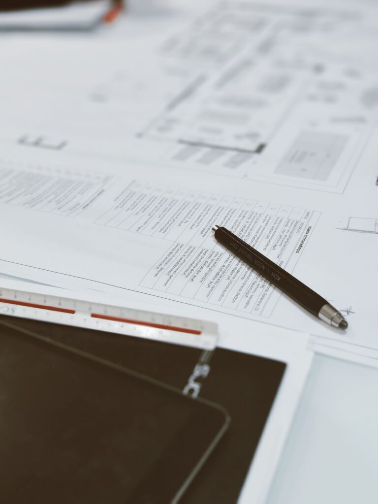A plan with a pen and an engineer's scale