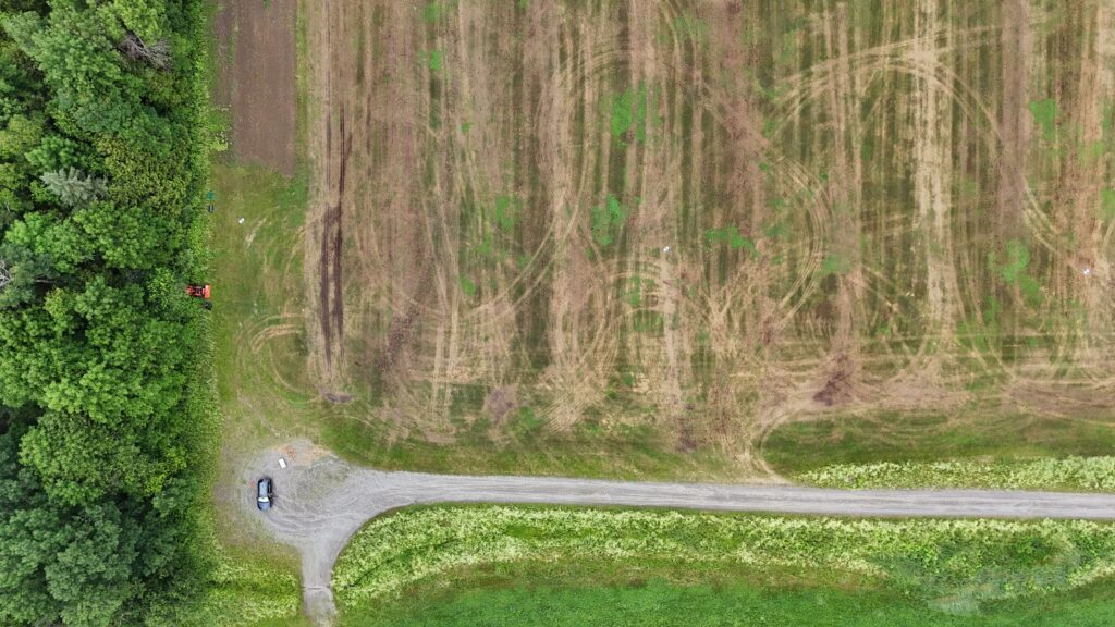 An aerial view of a field with a road